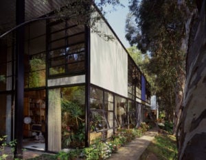 Exterior view of the Eames House, showing a contemporary looking home with beautiful landscaping
