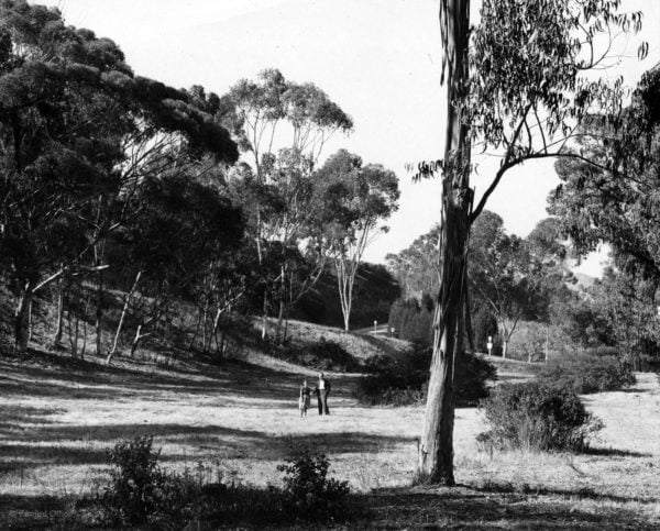 Charles and Ray Eames walk the grounds around the Eames House