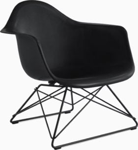 a molded fiberglass armchair with a black shell and a black wire base